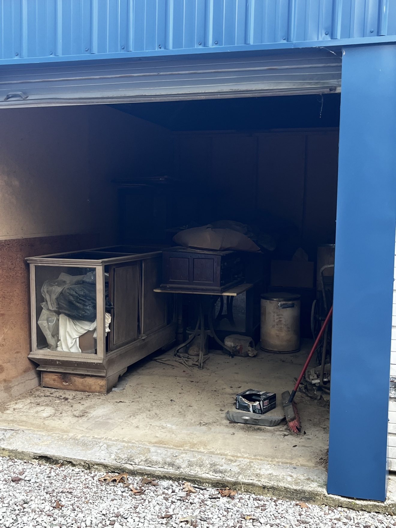 Storage locker filled with old furniture and household items before removal
